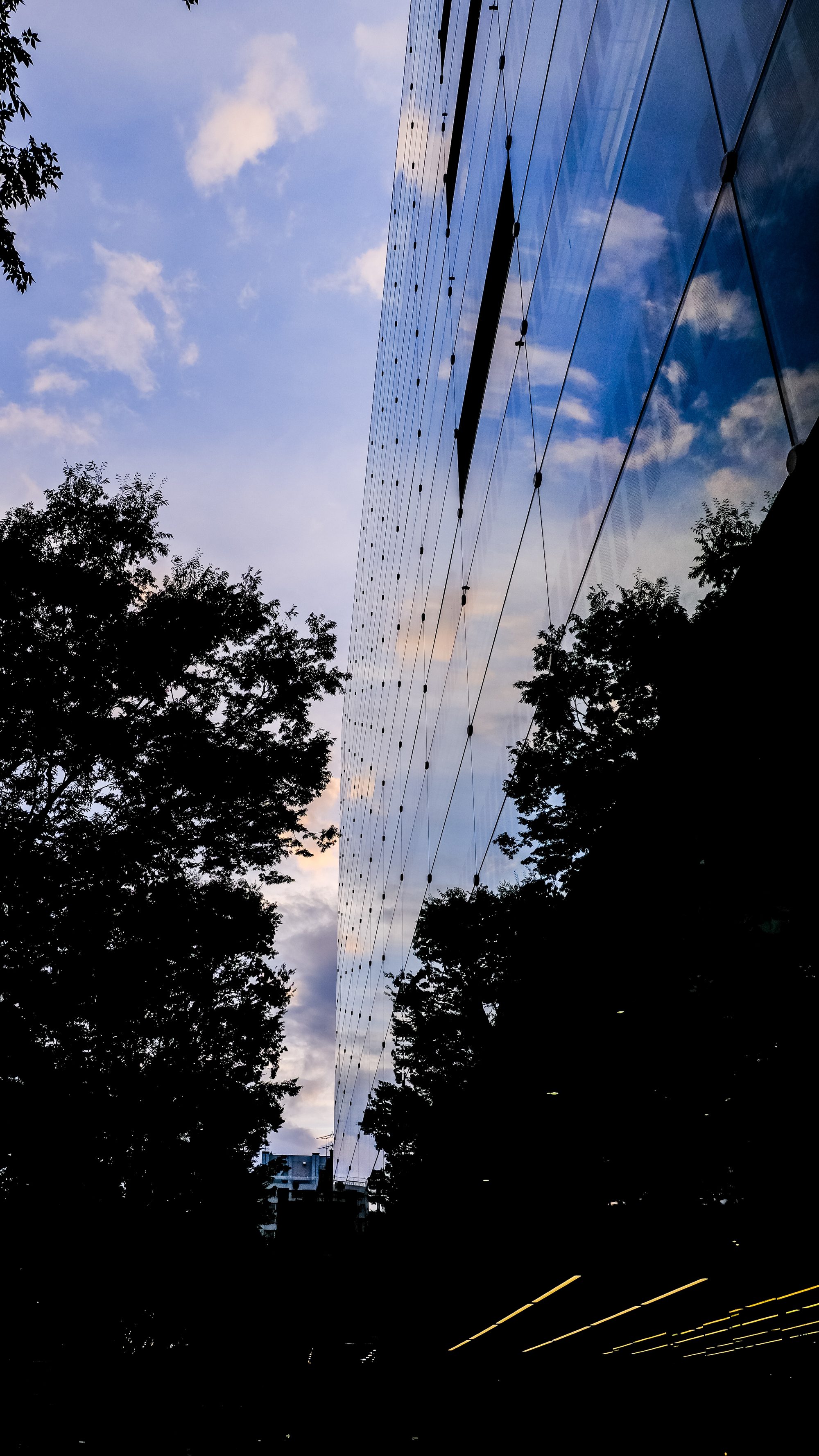 sky and clouds reflected on the wall of a building