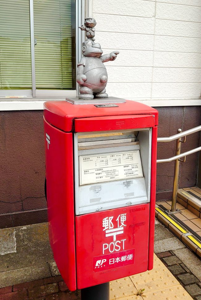 A post with a statue of comic character on the top