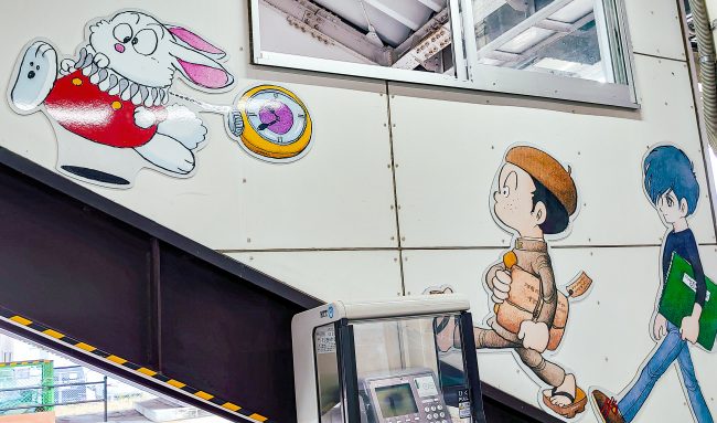Mural of manga characters painted on the wall at a station